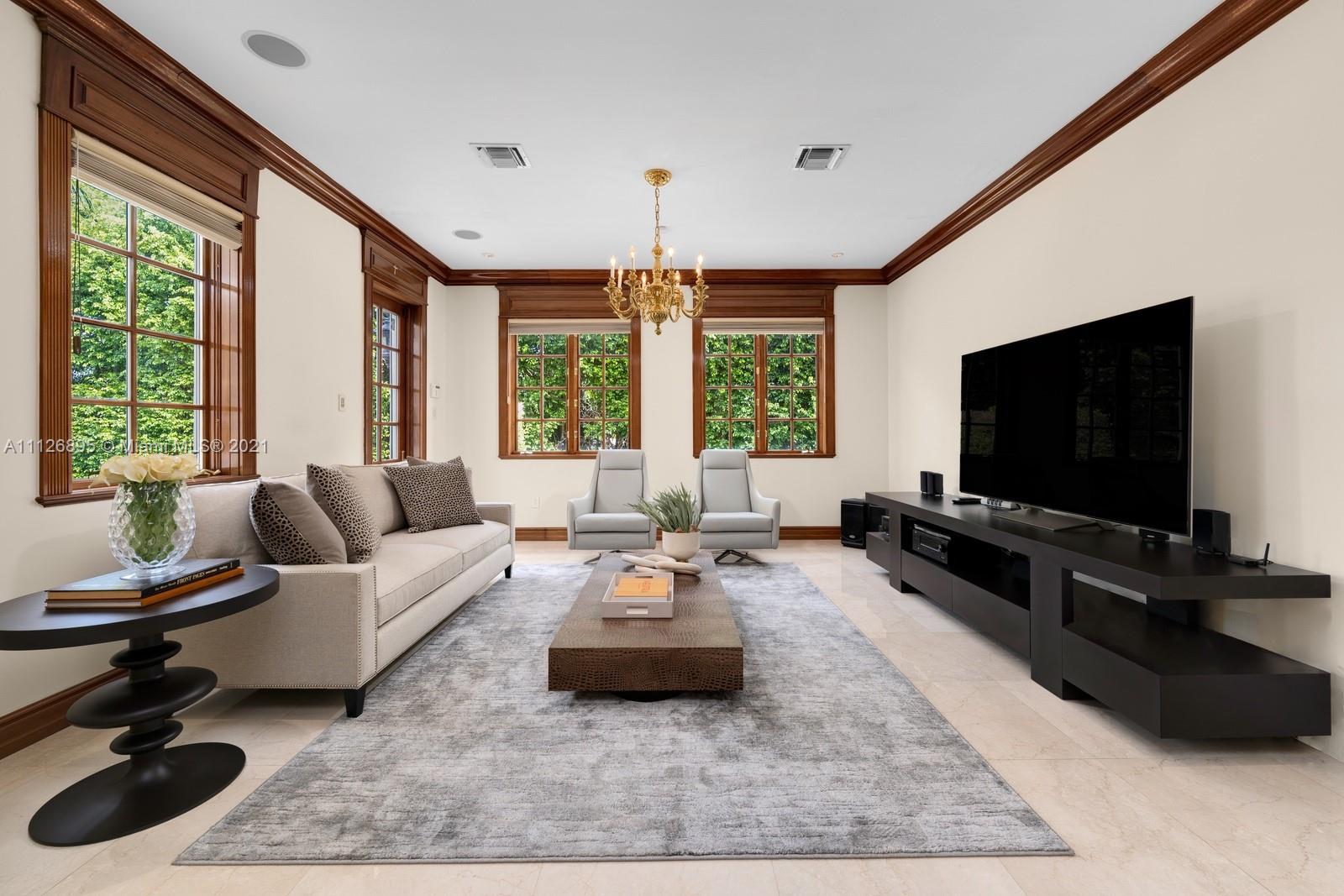 Aerial view of waterfront villa at 585 Arvida Pkwy, Miami, surrounded by lush greenery