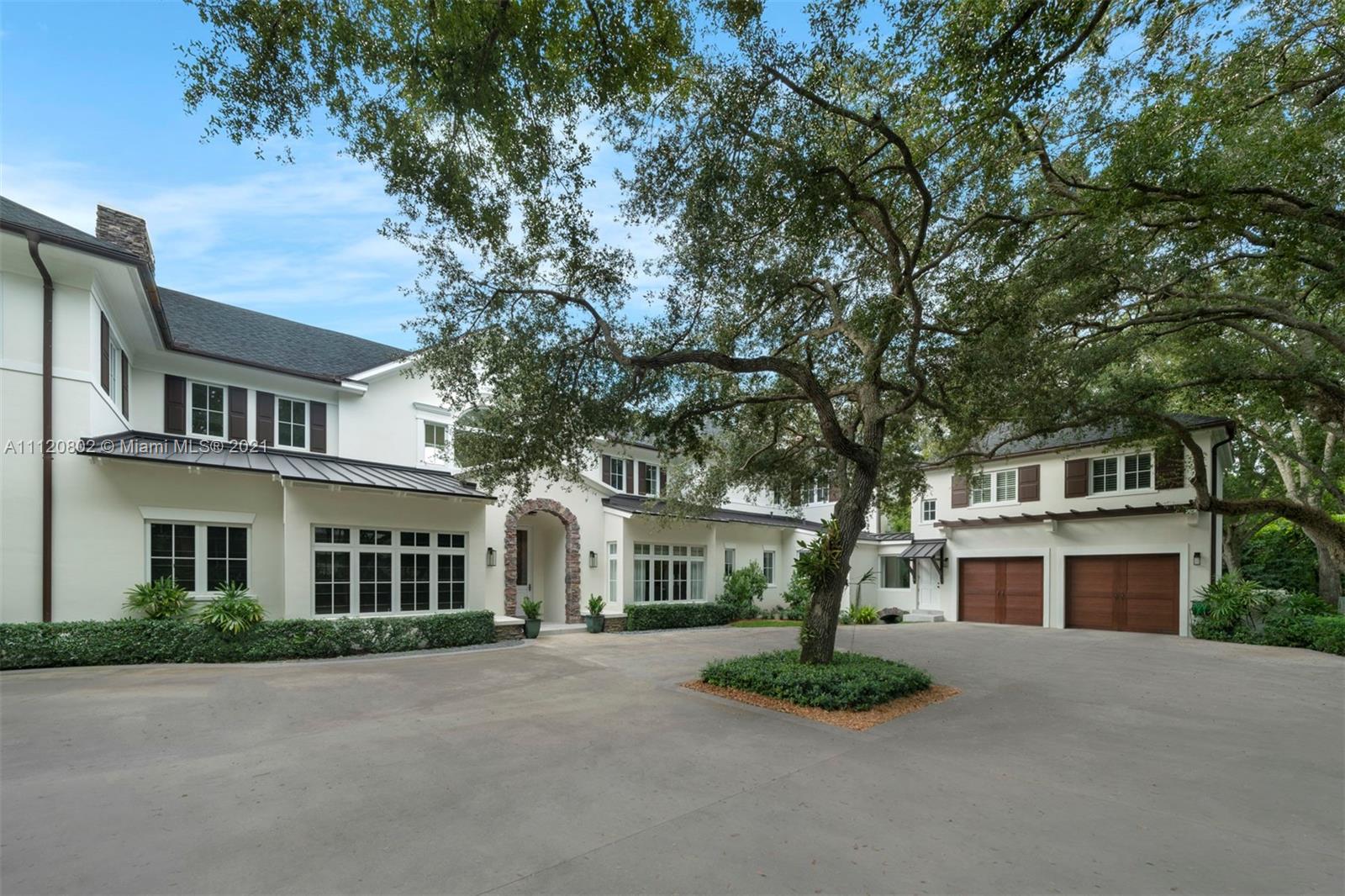 Luxurious eight-bedroom villa for sale in Miami, Florida, with spacious lawn and elegant facade