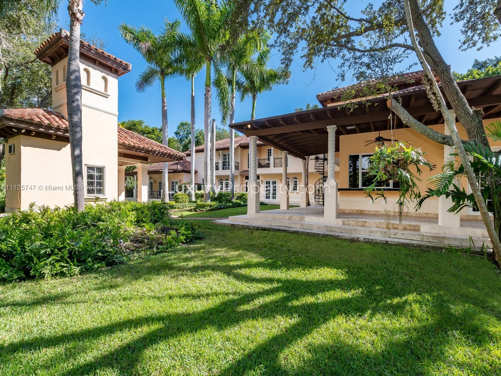 8-bed luxury villa exterior with garage and palm trees, Old Cutler Rd, Miami