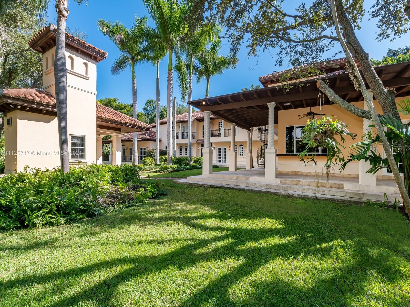 8-bed luxury villa exterior with garage and palm trees, Old Cutler Rd, Miami