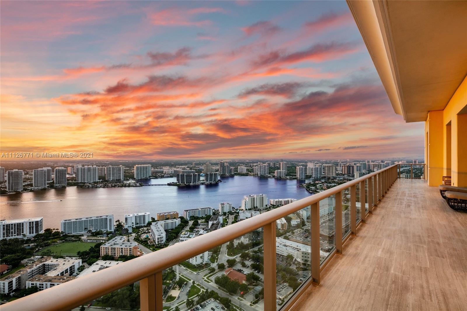 "Stunning Miami oceanfront skyline view from luxury villa at sunset, Collins Ave, Florida.",Oceanfront Miami villa balcony with stunning sunset views over Collins Avenue, Florida