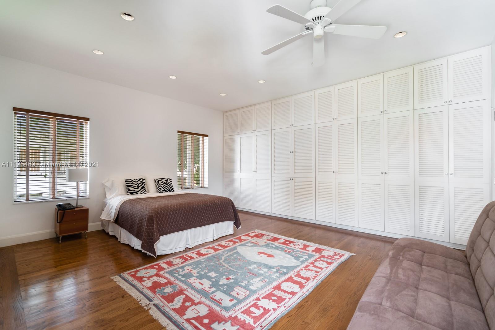 Interior of luxurious Miami villa with modern kitchen, spiral staircase, and cozy living area