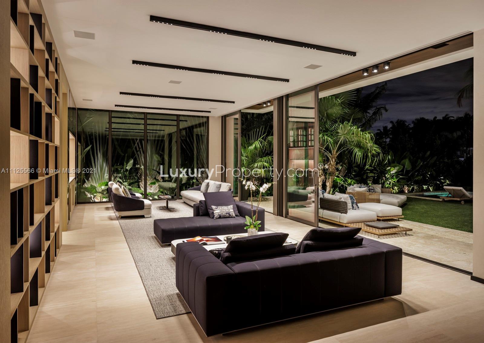 Luxurious Miami waterfront villa with pool, modern architecture, and lush landscaping for sale