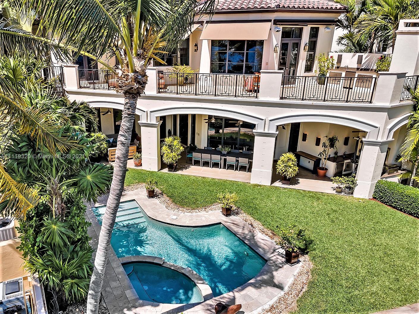 Aerial view of waterfront mansion at 4036 Island Estates Dr, Aventura, with pool and palm trees