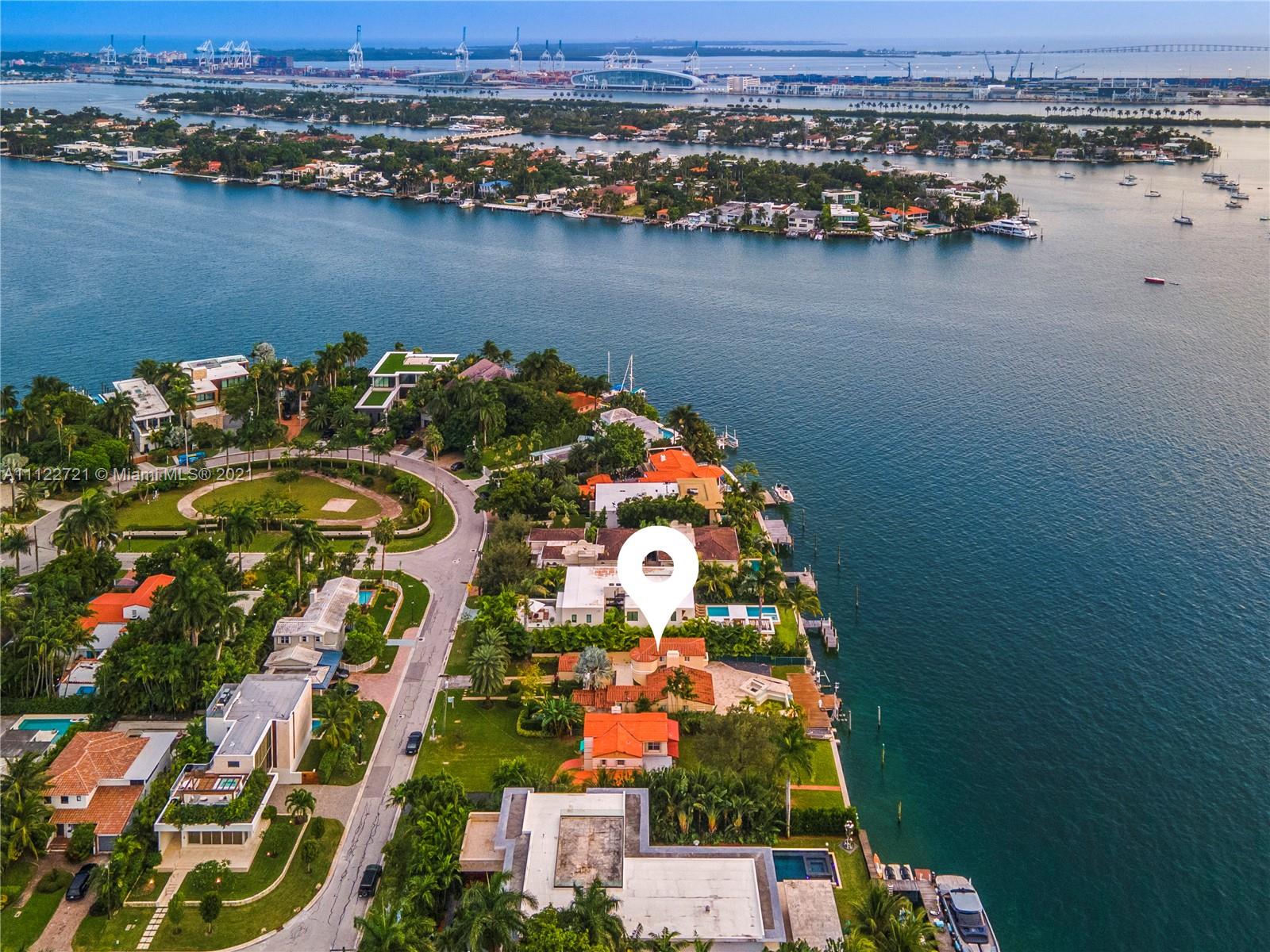 Aerial view of Miami villa for sale at 114 W San Marino Dr, skyline backdrop