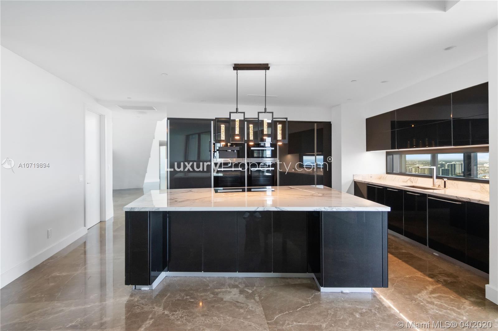 Luxurious Miami duplex kitchen with ocean view, modern design, and sleek finishes