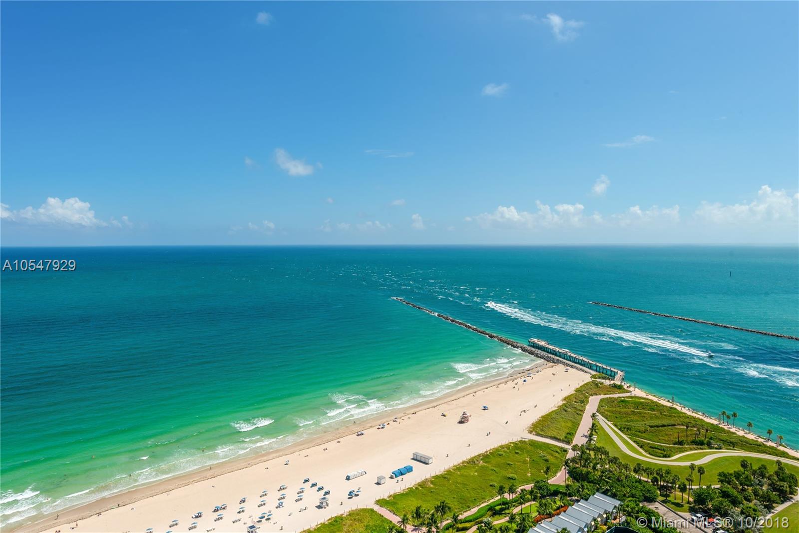 "Elegant bathroom in luxury Miami villa with marble sink and modern fixtures for sale.",Luxury villa bathroom with marble shower at 50 S Pointe Drive, Miami