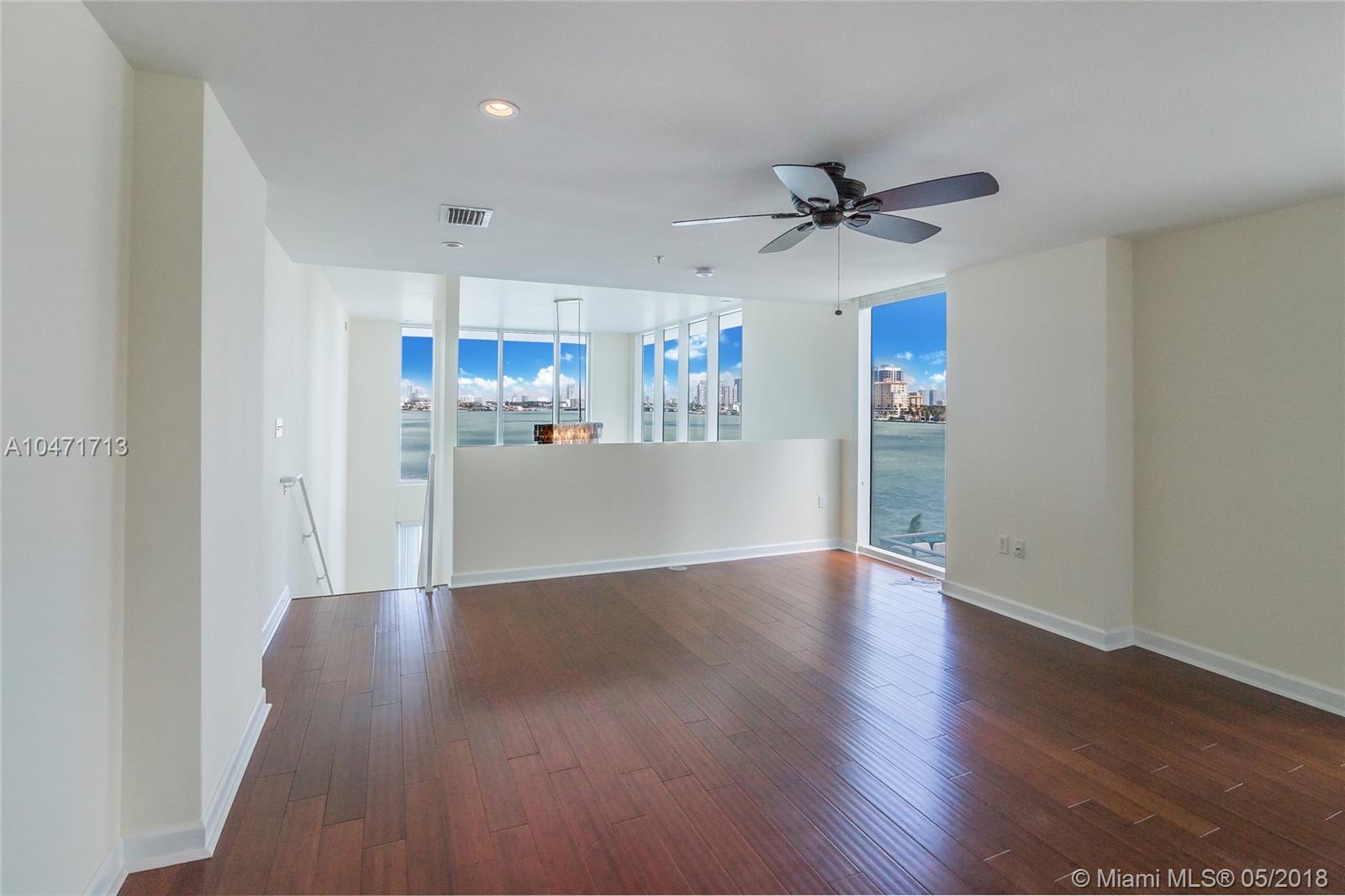 "Waterfront condo with pool for sale in Miami's North Bay Island, Florida.",Waterfront condo interior with hardwood floors and ocean view in North Bay Island, Miami