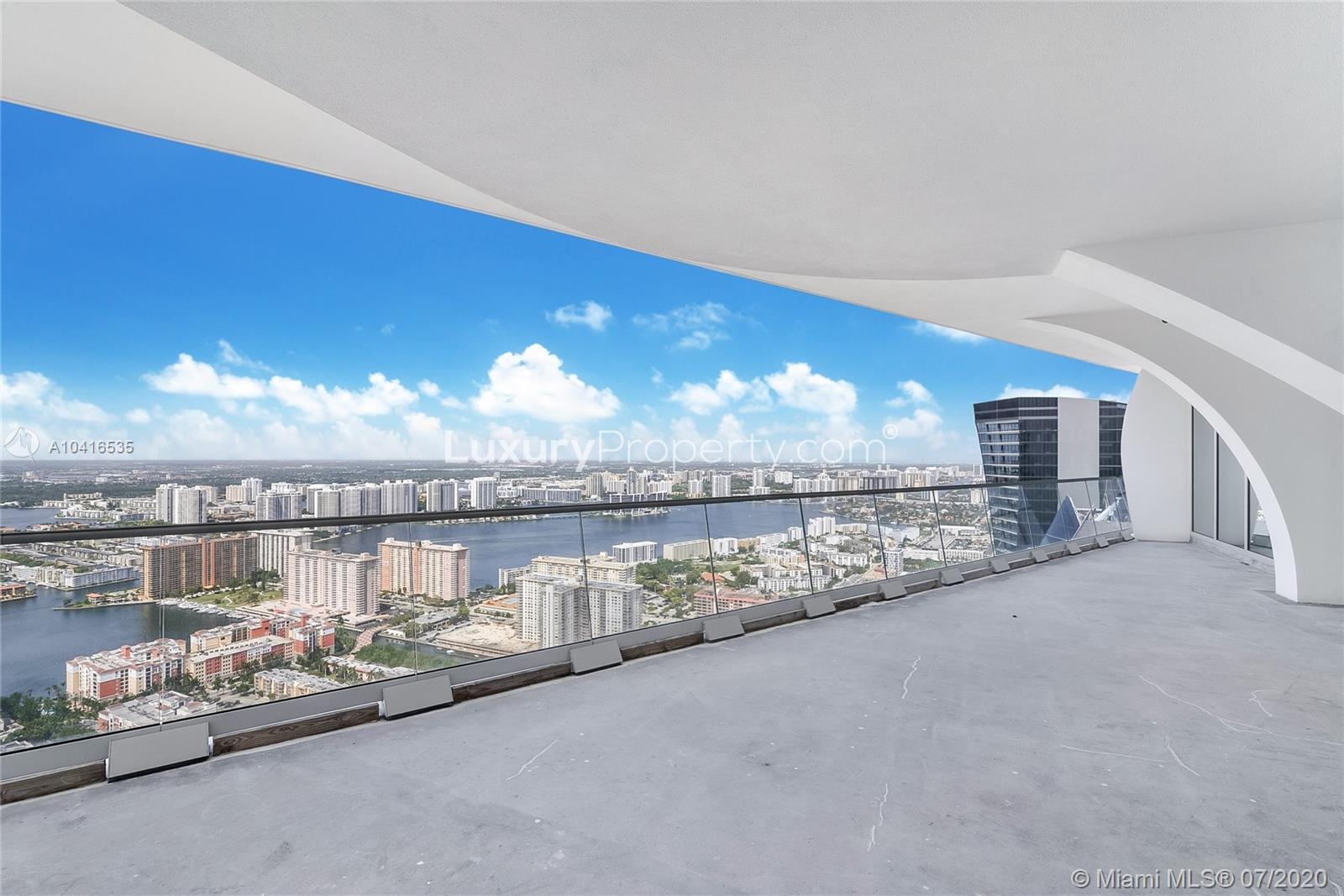 Luxurious Miami penthouse interior with ocean view, large windows, modern design