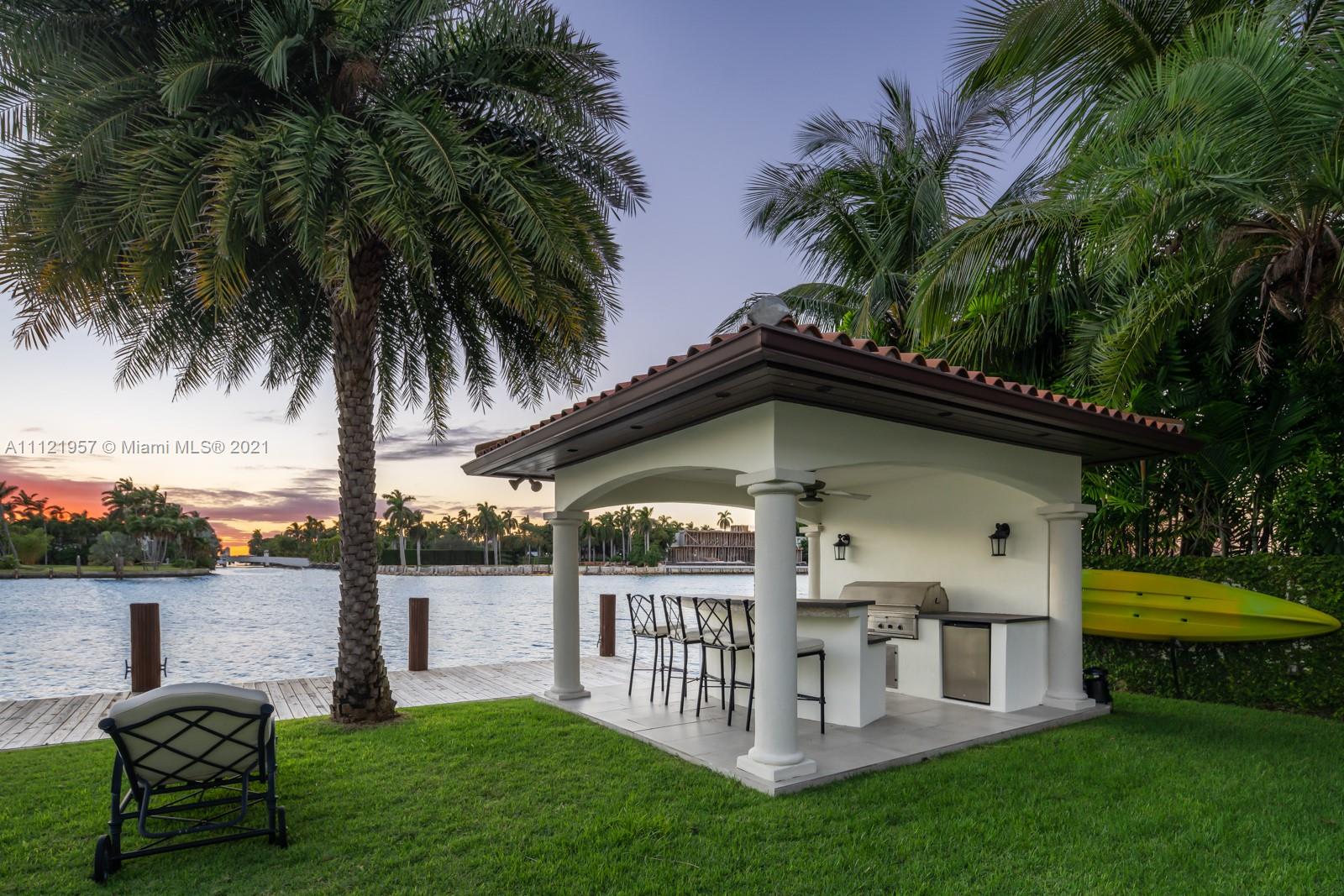 Waterfront villa in Miami with outdoor kitchen and stunning sunset view, Florida real estate