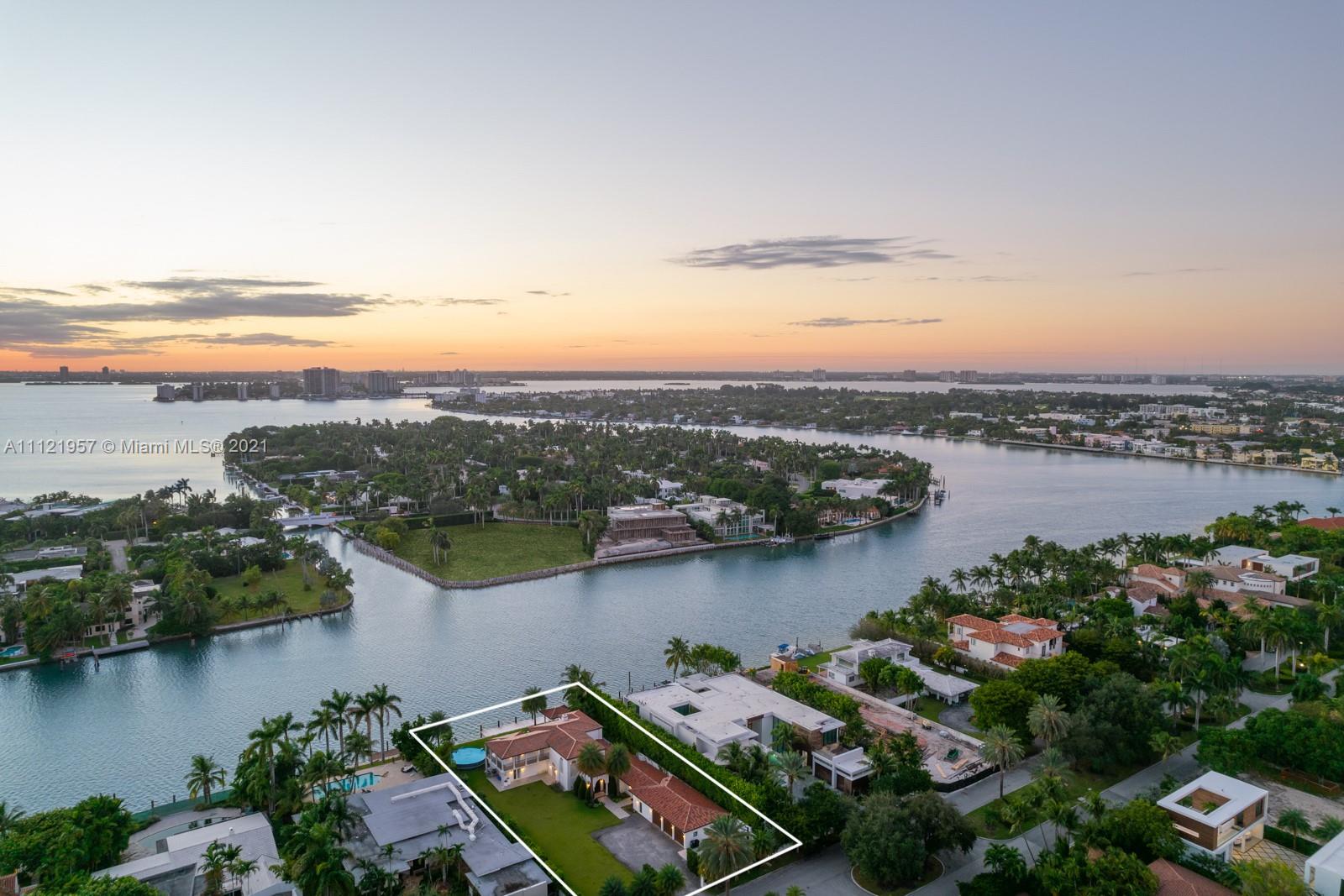 Aerial view of waterfront Mediterranean villa for sale in Miami, Florida at sunset