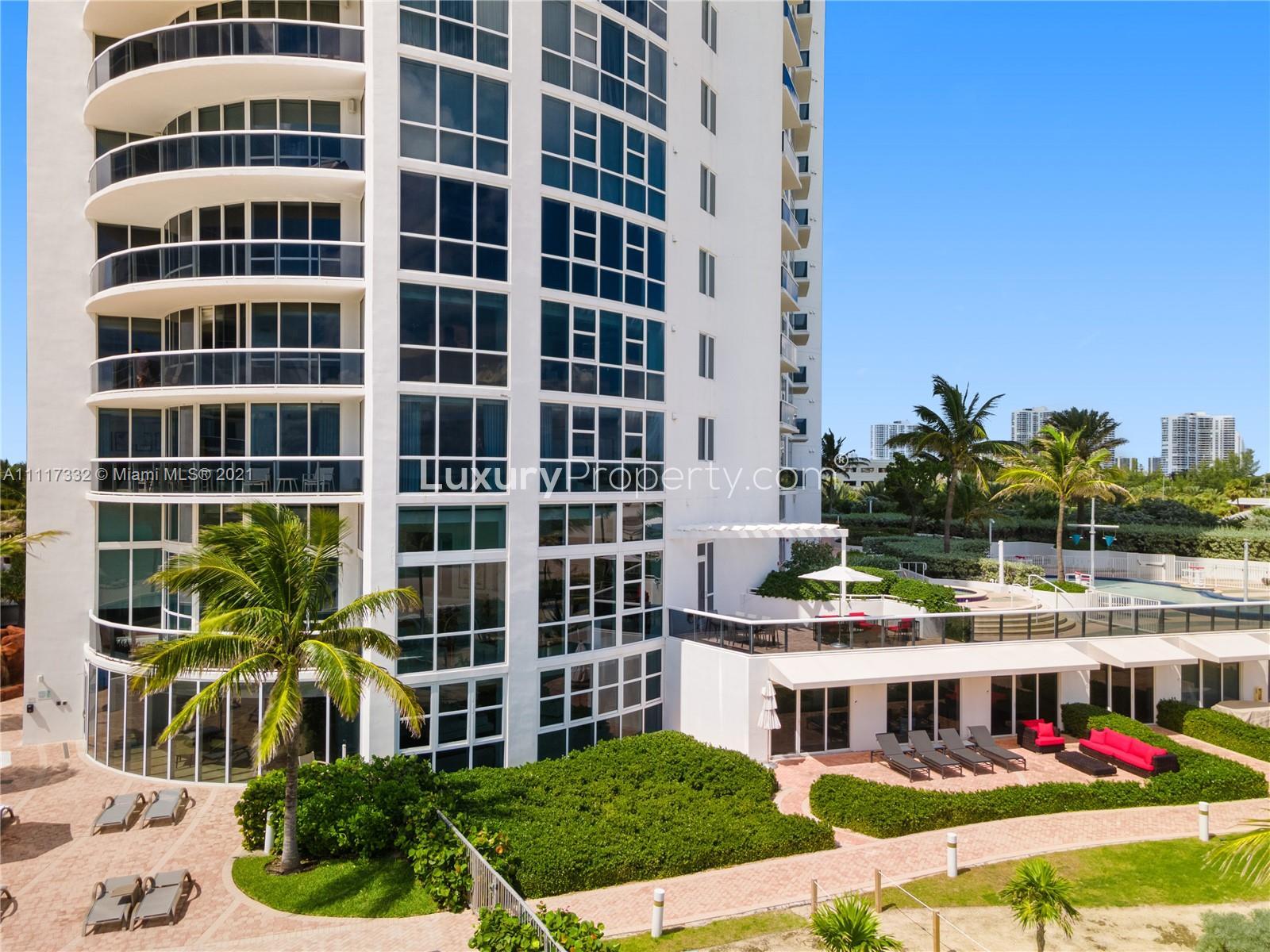 Modern kitchen and dining area with ocean views in Miami beach villa, 18201 Collins Ave
