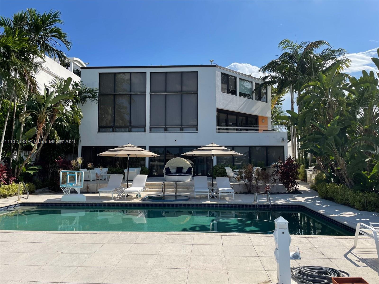 Custom-built waterfront villa with pool at night, 279 N Hibiscus Dr, Miami