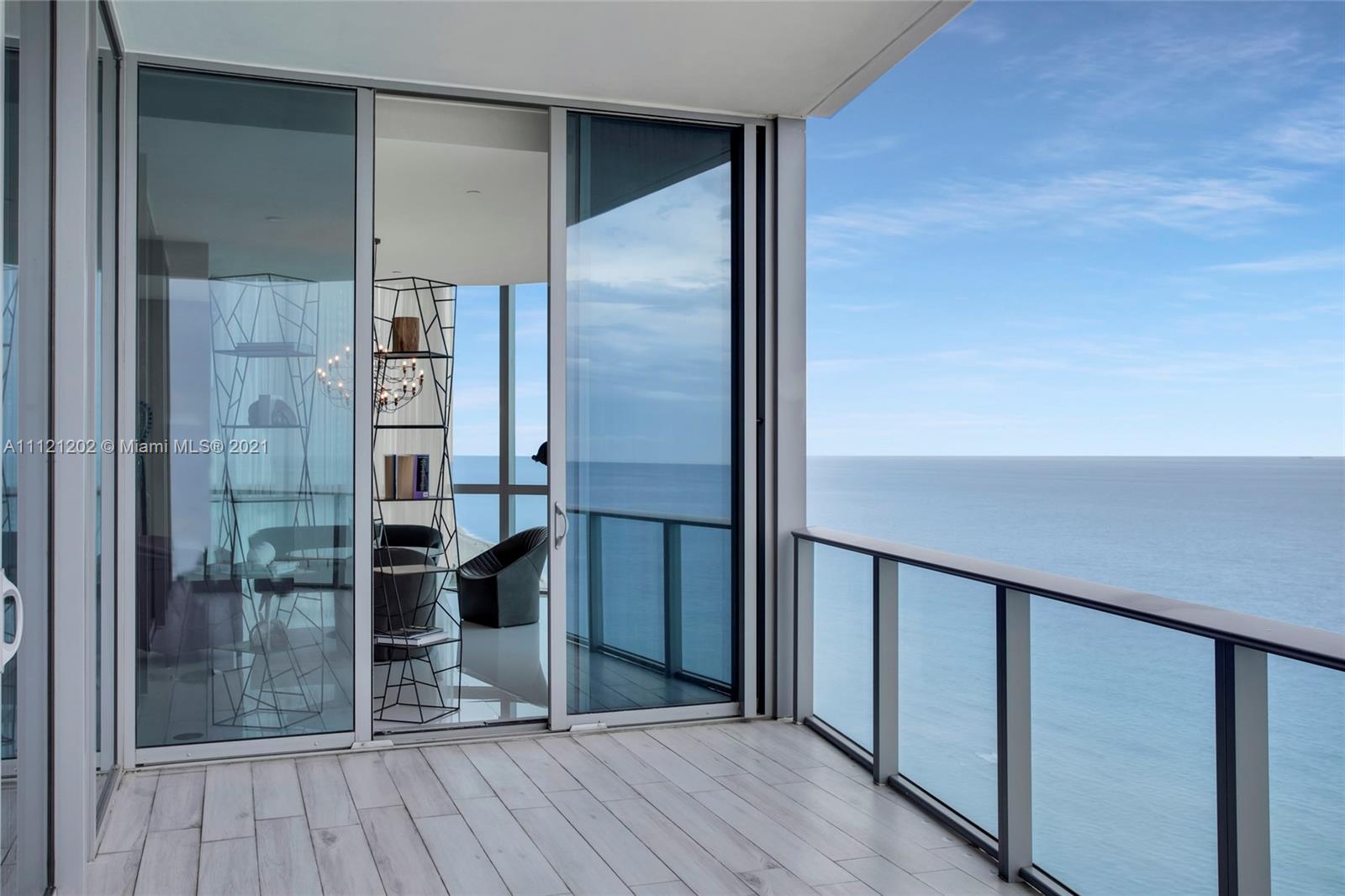 "Luxury Miami villa balcony with ocean view at 17475 Collins Ave, 4-bed, 6-bath.",Alt text: "Ocean view from luxury Miami villa at 17475 Collins Ave, Florida, for sale.","Stunning ocean view from luxury villa balcony at 17475 Collins Ave, Miami, Florida.",Luxury Miami villa balcony with ocean view at 17475 Collins Ave, for sale