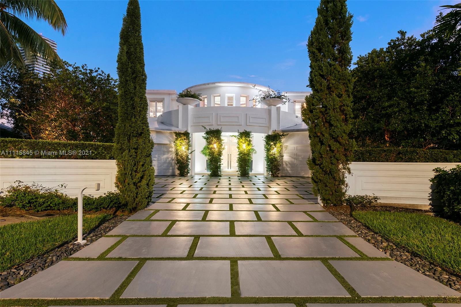 Aerial view of waterfront villa in Golden Beach, Florida, featuring lush surroundings and ocean