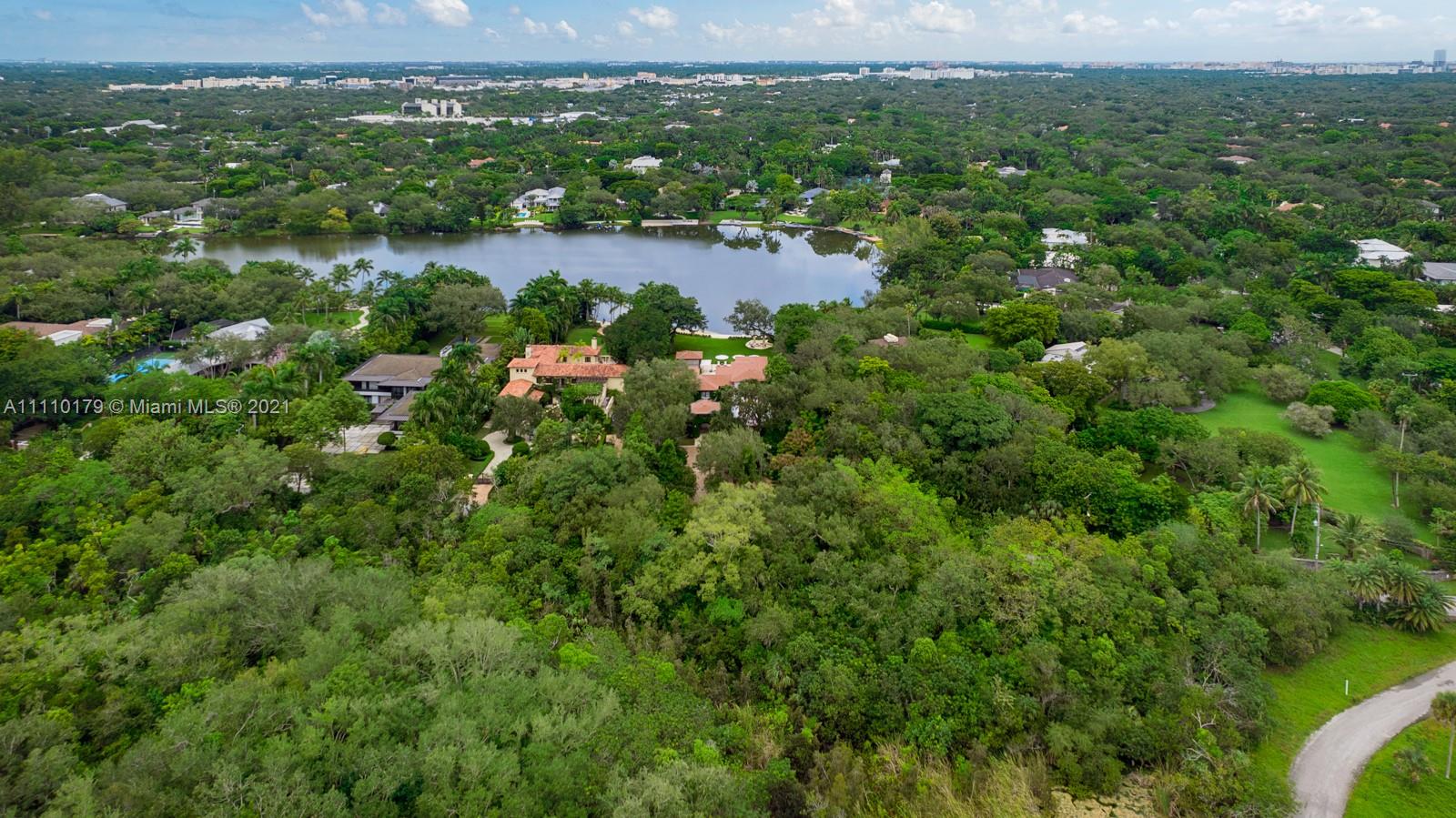 Aerial view of luxury villa for sale in Miami, Florida surrounded by lush greenery