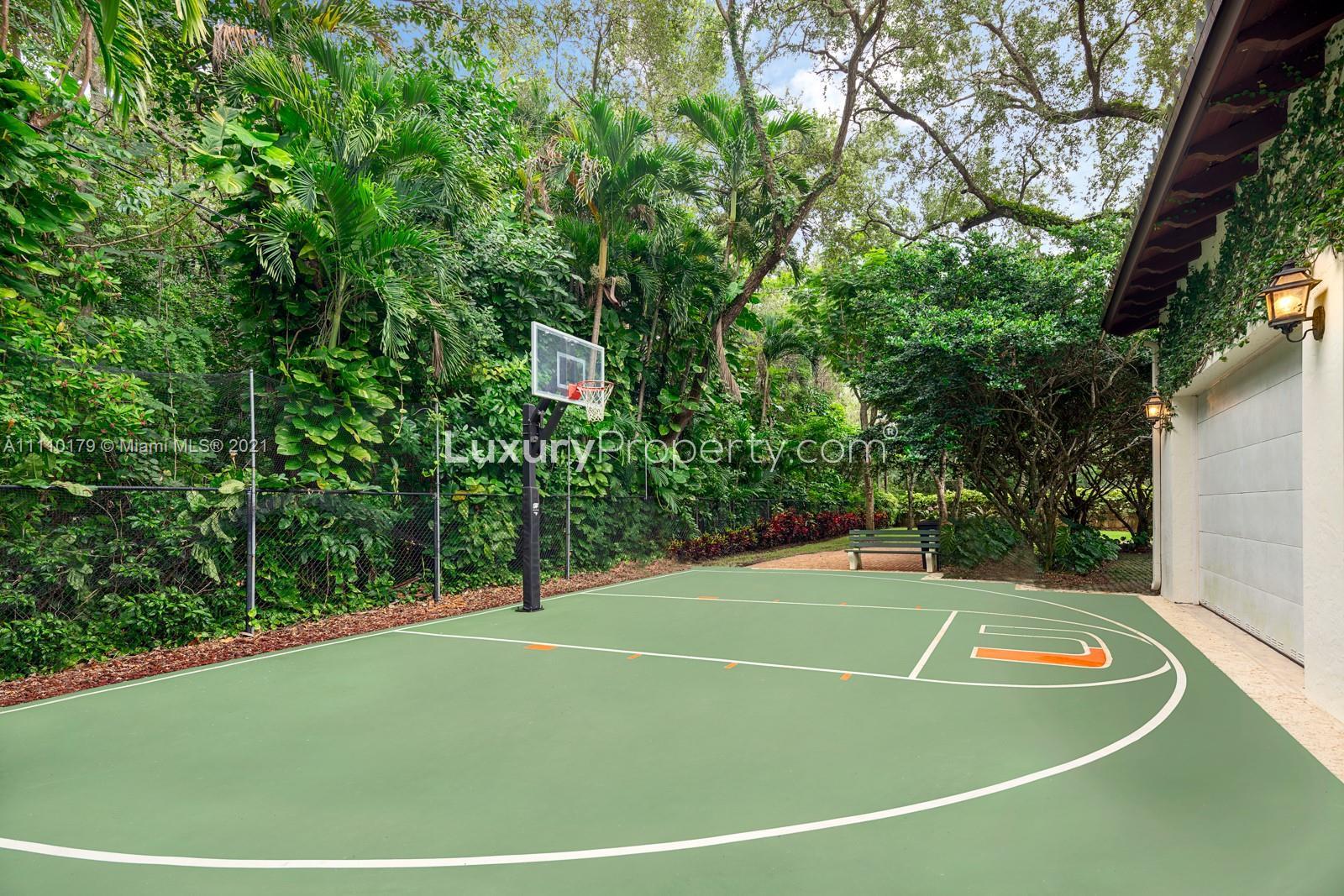 Aerial view of luxury villa surrounded by lush greenery in Miami, Florida, for sale
