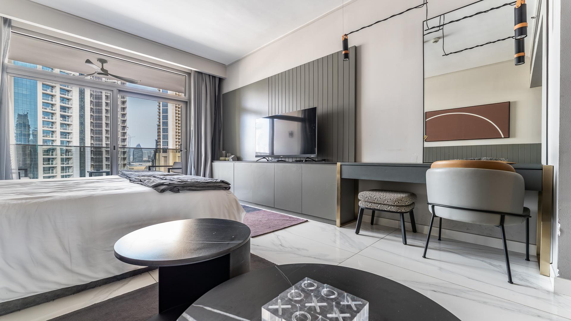 Furnished studio apartment interior at MAG 318, Business Bay, featuring modern decor and cozy ambiance
