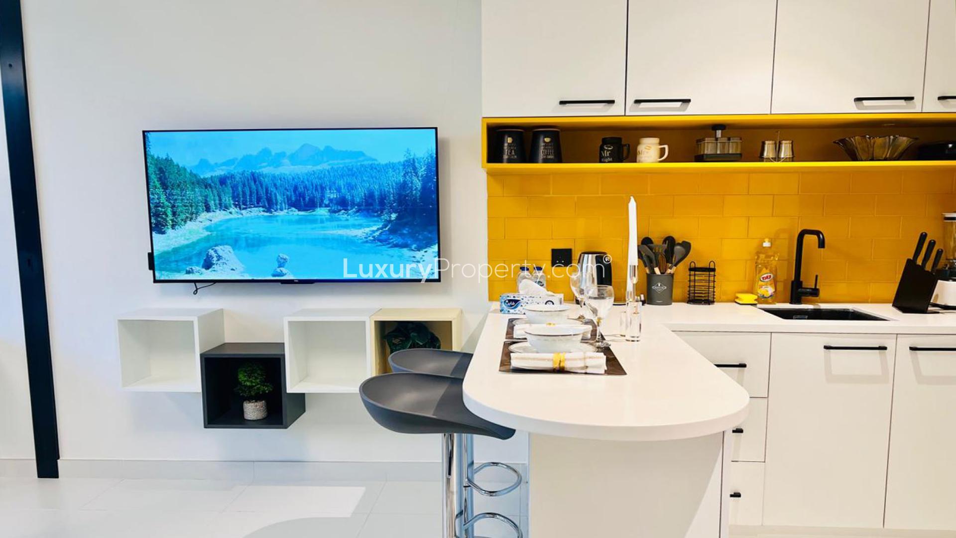 Fully furnished studio interior at LOCI Residences, Jumeirah Village Circle, with modern decor