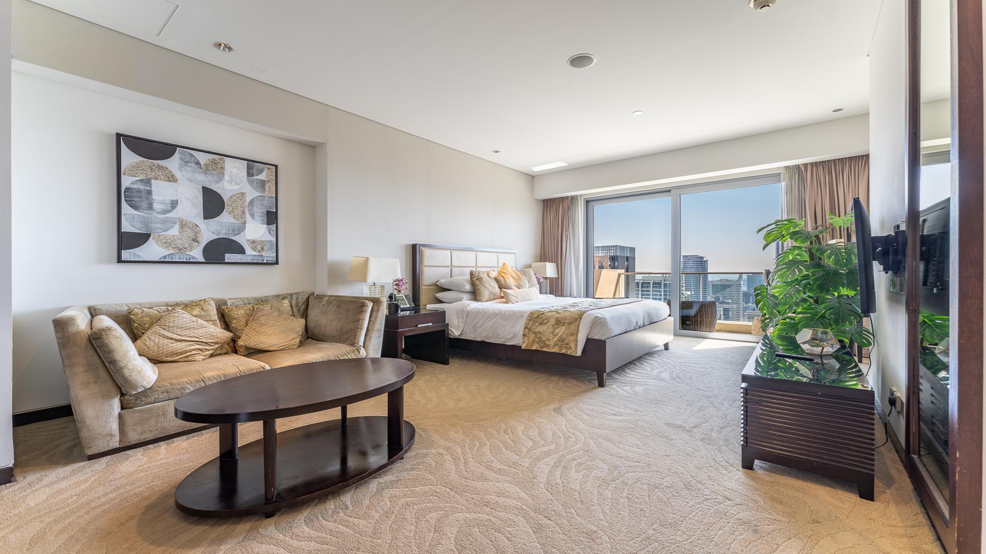 Fully furnished studio apartment bedroom in JW Marriott, Dubai Marina, with modern decor