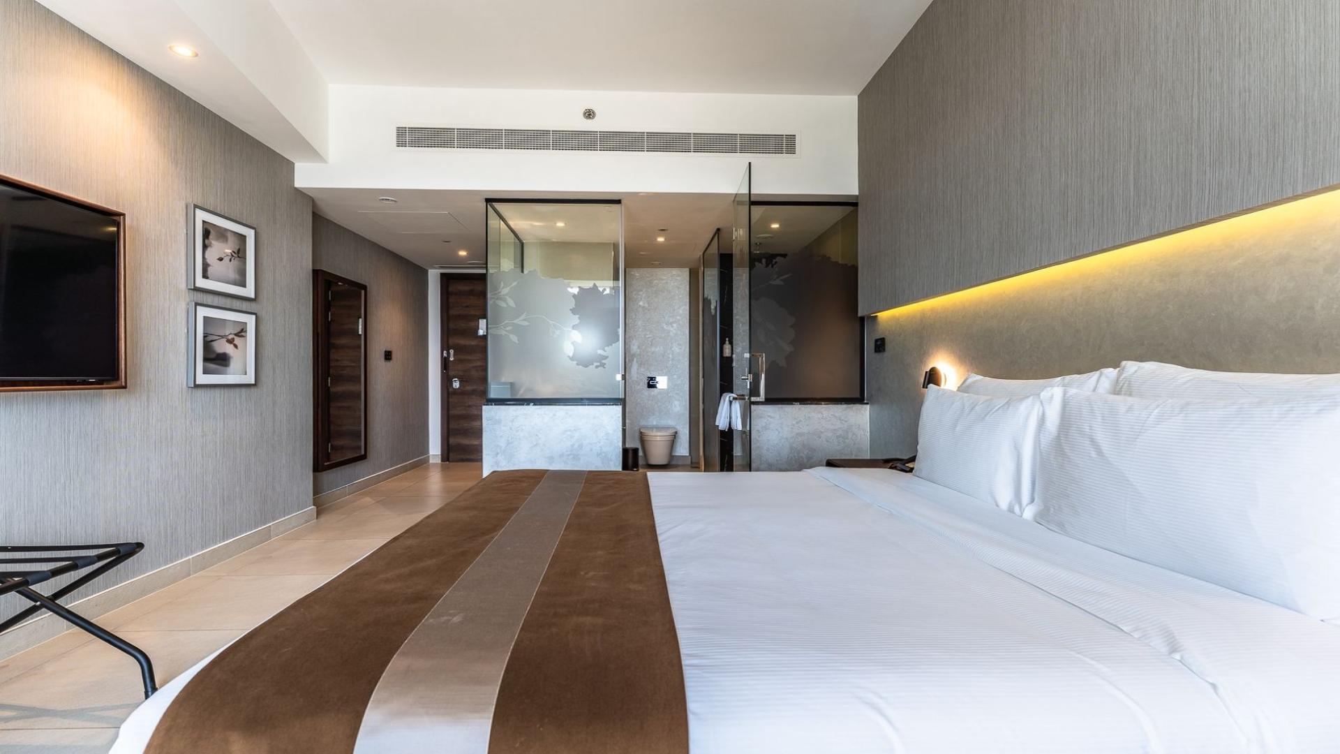 Fully furnished studio apartment bedroom with city view at Jumeirah Village Triangle