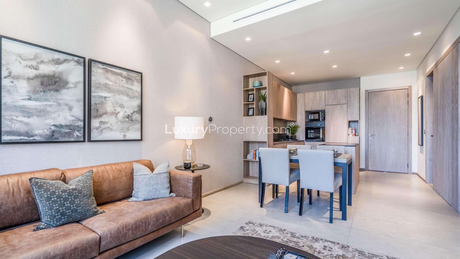 Modern studio living room with leather sofas at Signature Livings, Jumeirah Village Circle apartment