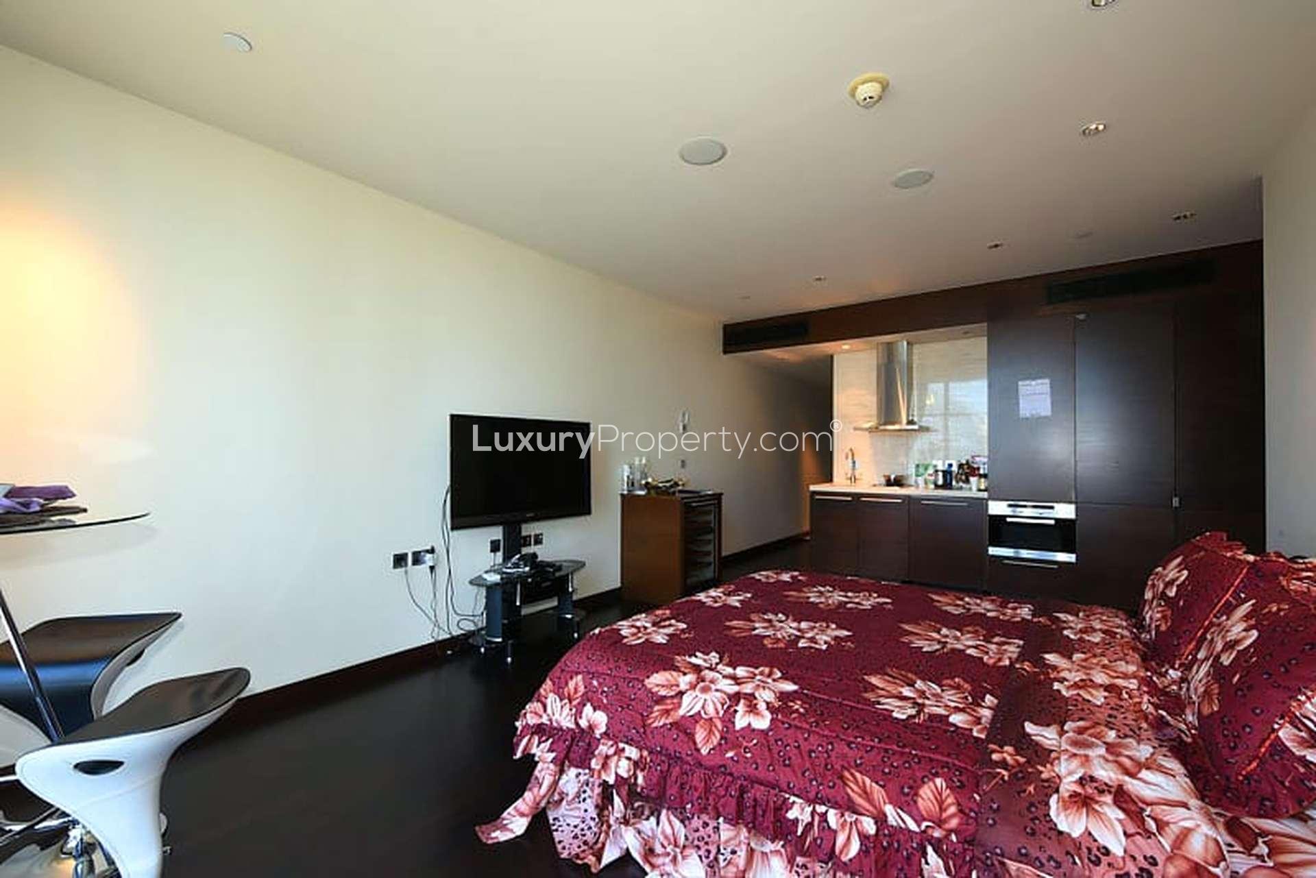 Aerial view of Downtown Dubai near Burj Khalifa, featuring lush greenery and modern architecture