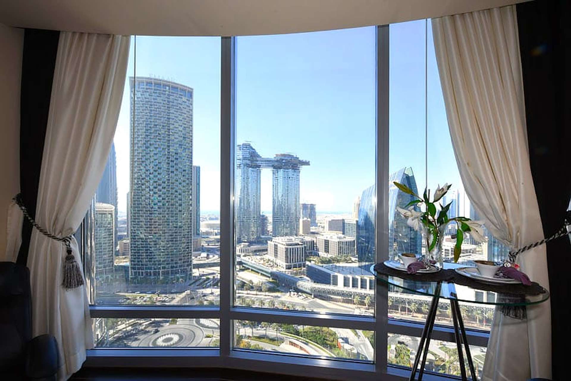 "Stunning city view from studio apartment in Burj Khalifa, Downtown Dubai, available for rent.",Fully furnished studio apartment interior with city view in Burj Khalifa, Downtown Dubai