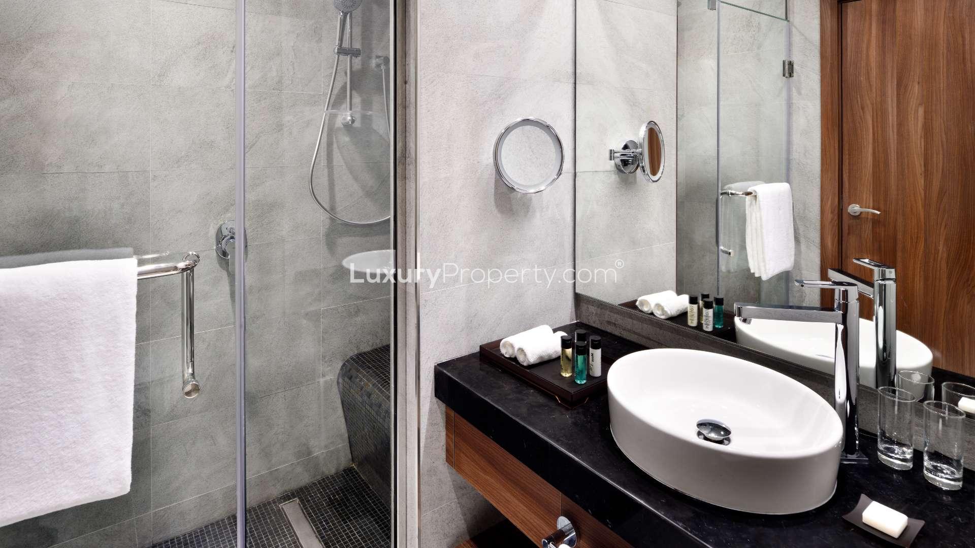 Modern kitchenette in furnished Downtown Dubai studio for rent, featuring sleek design and amenities