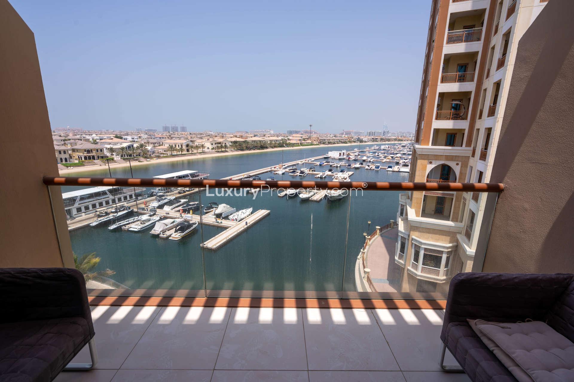 Studio apartment interior with modern furnishings, large window, Palm Jumeirah, sea view