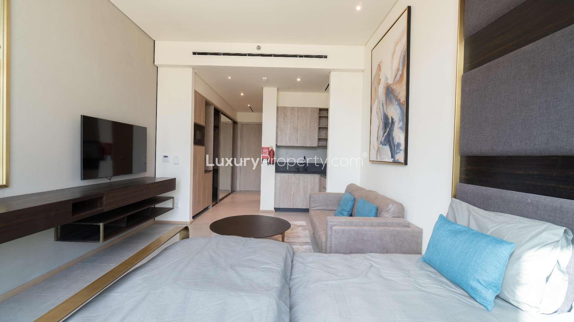 Furnished studio apartment in Signature Livings, JVC with modern decor and large window view