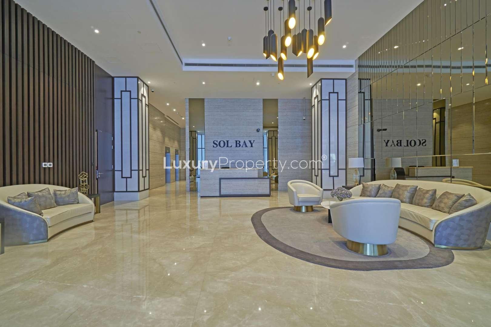 "Modern SOL Bay apartment building exterior in Business Bay, ideal for urban studio living.",Luxurious SOL Bay apartment lobby with modern decor in Business Bay, available for rent