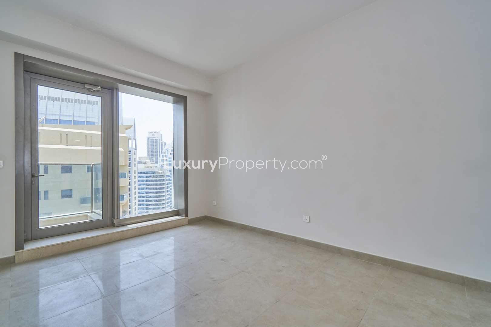 Empty studio apartment with large window, partial marina views in Sparkle Towers, Dubai Marina