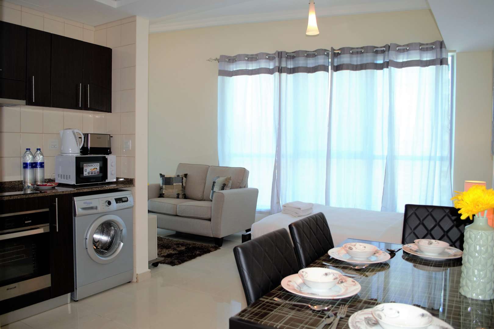 Studio apartment interior in Bay Central, Dubai Marina, featuring modern kitchen and dining area