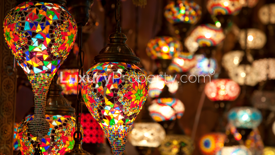 "Modern high-rise apartment building in Jumeirah Village Circle, District 18, at sunset.",Colorful mosaic lamps in studio apartment for sale, Jumeirah Village Circle, District 18