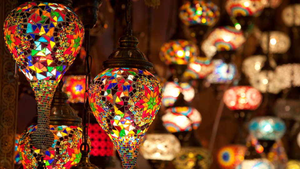 "Modern high-rise apartment building in Jumeirah Village Circle, District 18, at sunset.",Colorful mosaic lamps in studio apartment for sale, Jumeirah Village Circle, District 18