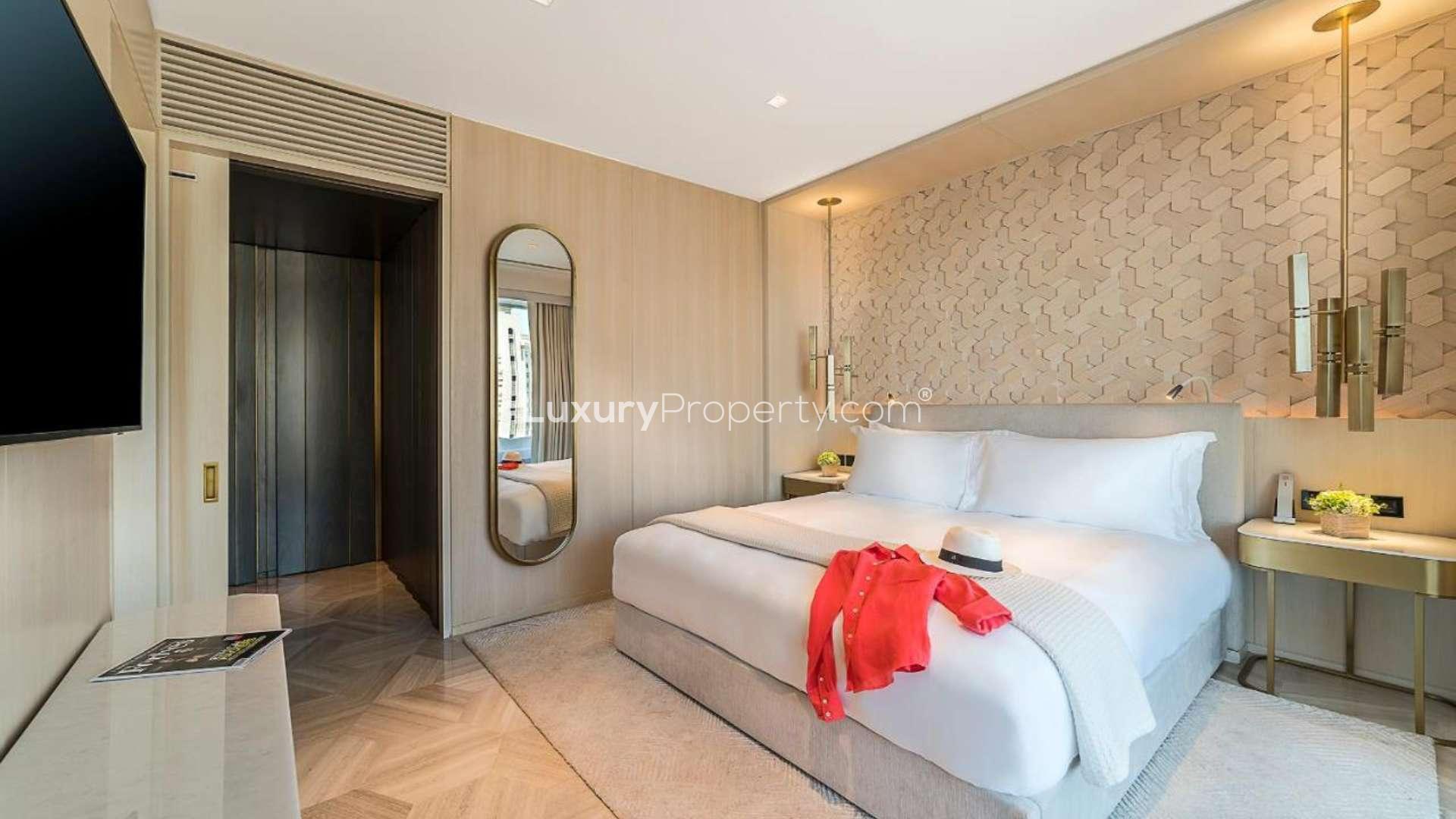 Luxurious beachfront apartment view at FIVE Palm Jumeirah with sun loungers and umbrellas