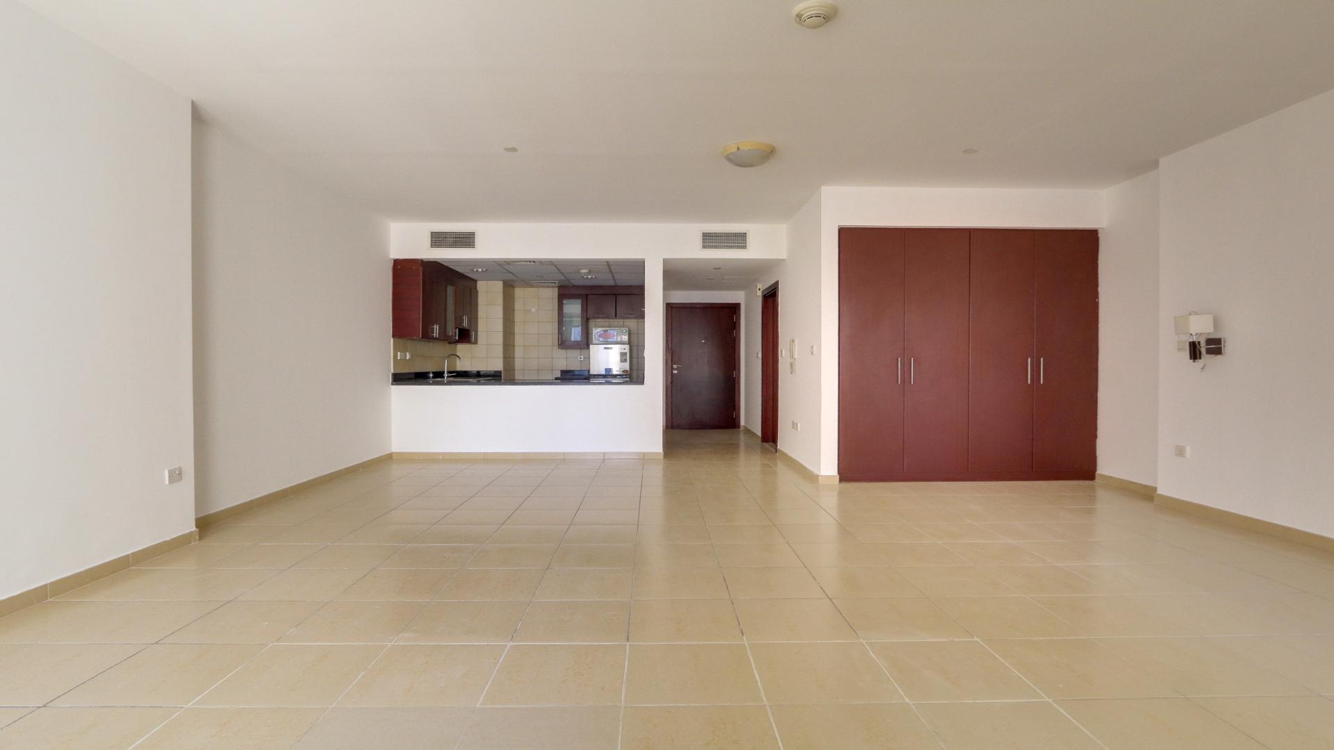 Studio apartment interior, spacious layout, tile flooring, modern kitchen in JBR Murjan, for sale