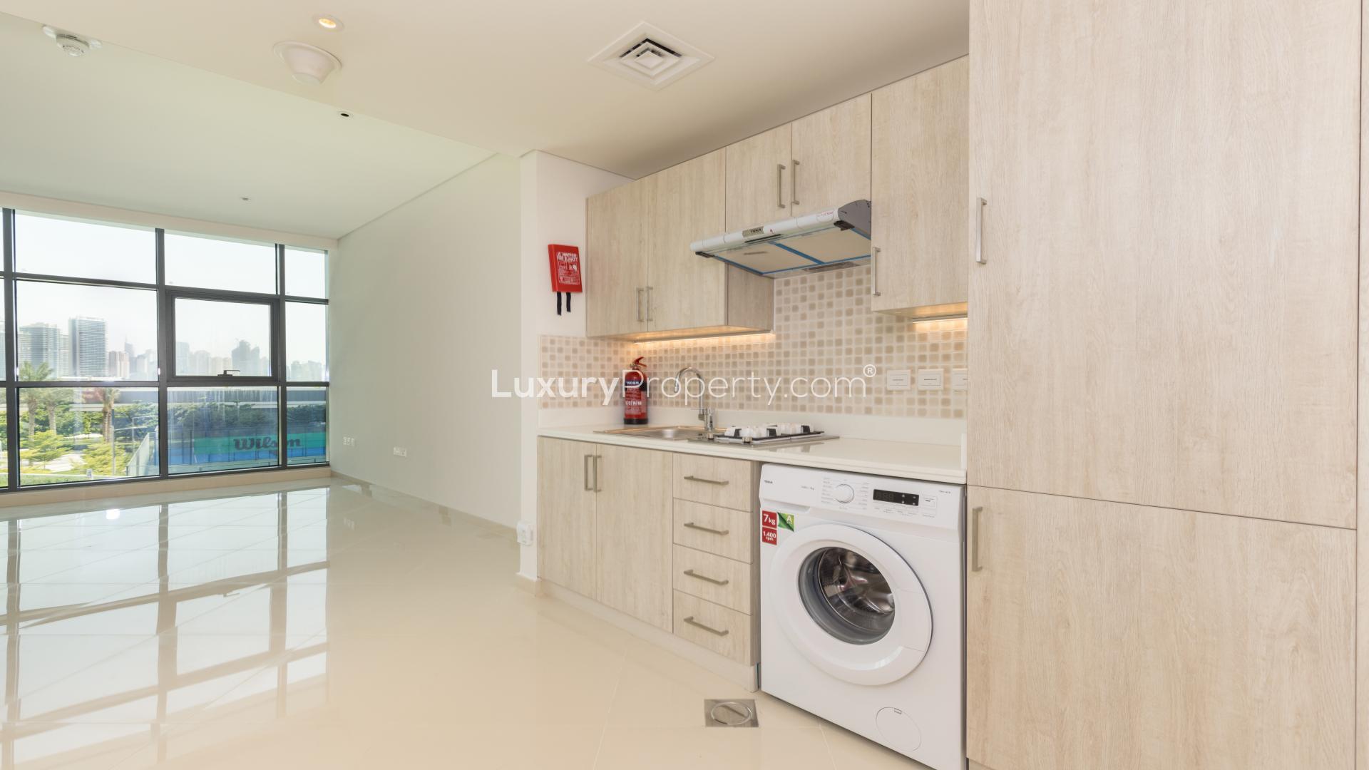 Modern kitchen in studio apartment, Seven Palm, Palm Jumeirah, with sleek cabinetry and appliances