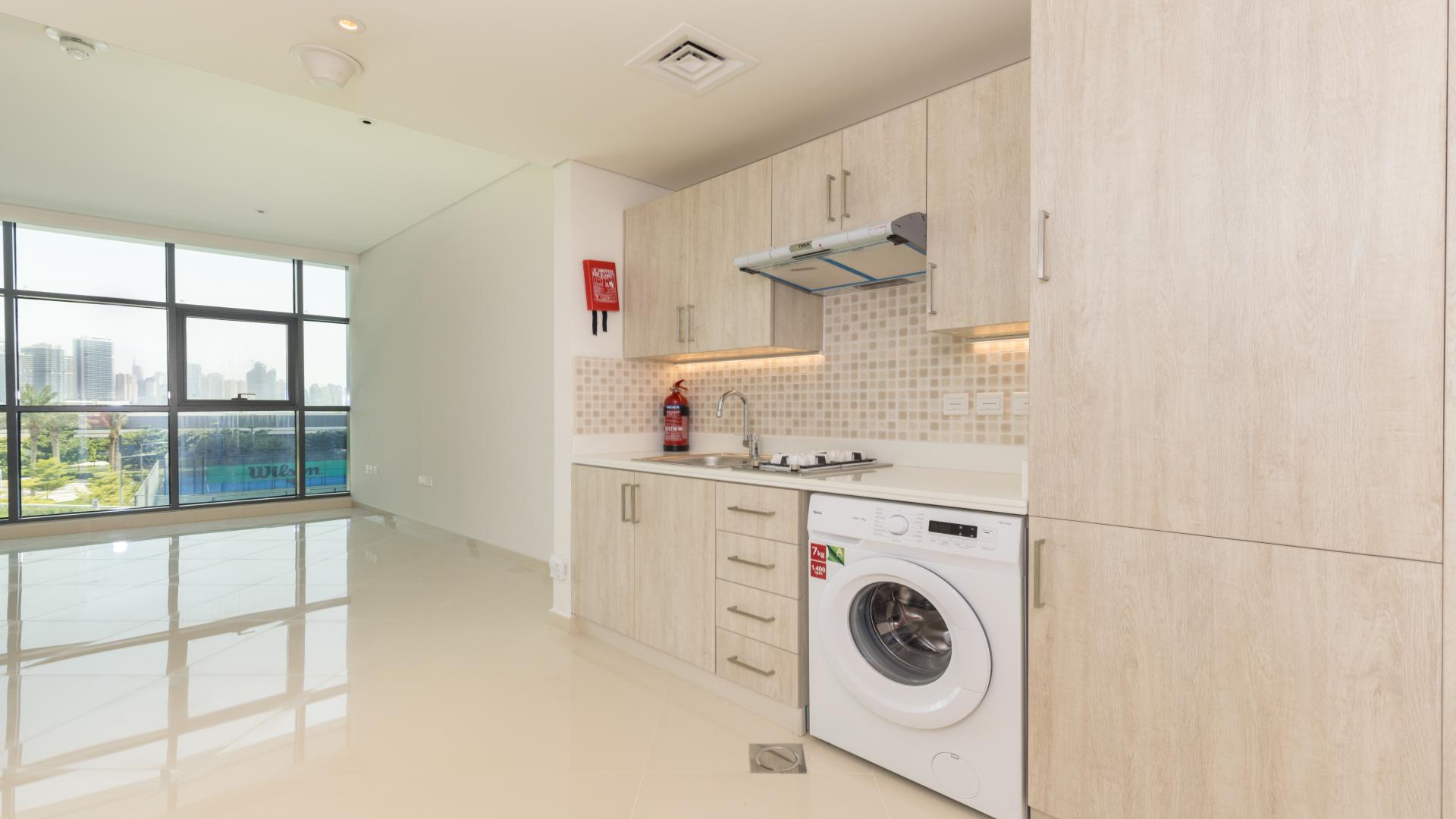Modern kitchen in studio apartment, Seven Palm, Palm Jumeirah, with sleek cabinetry and appliances