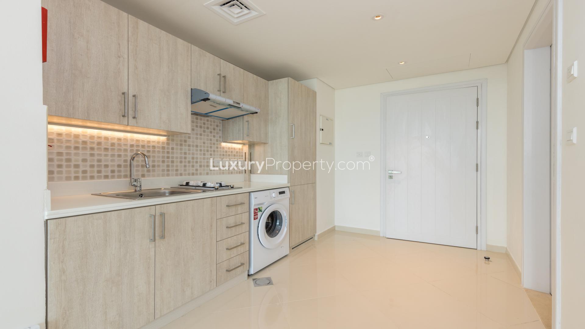 Empty modern studio apartment with large windows and sea view at Seven Palm, Palm Jumeirah