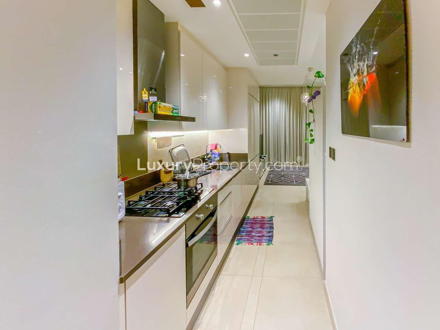 Furnished living area in studio apartment, Marina Gate, Dubai Marina, with modern decor and TV