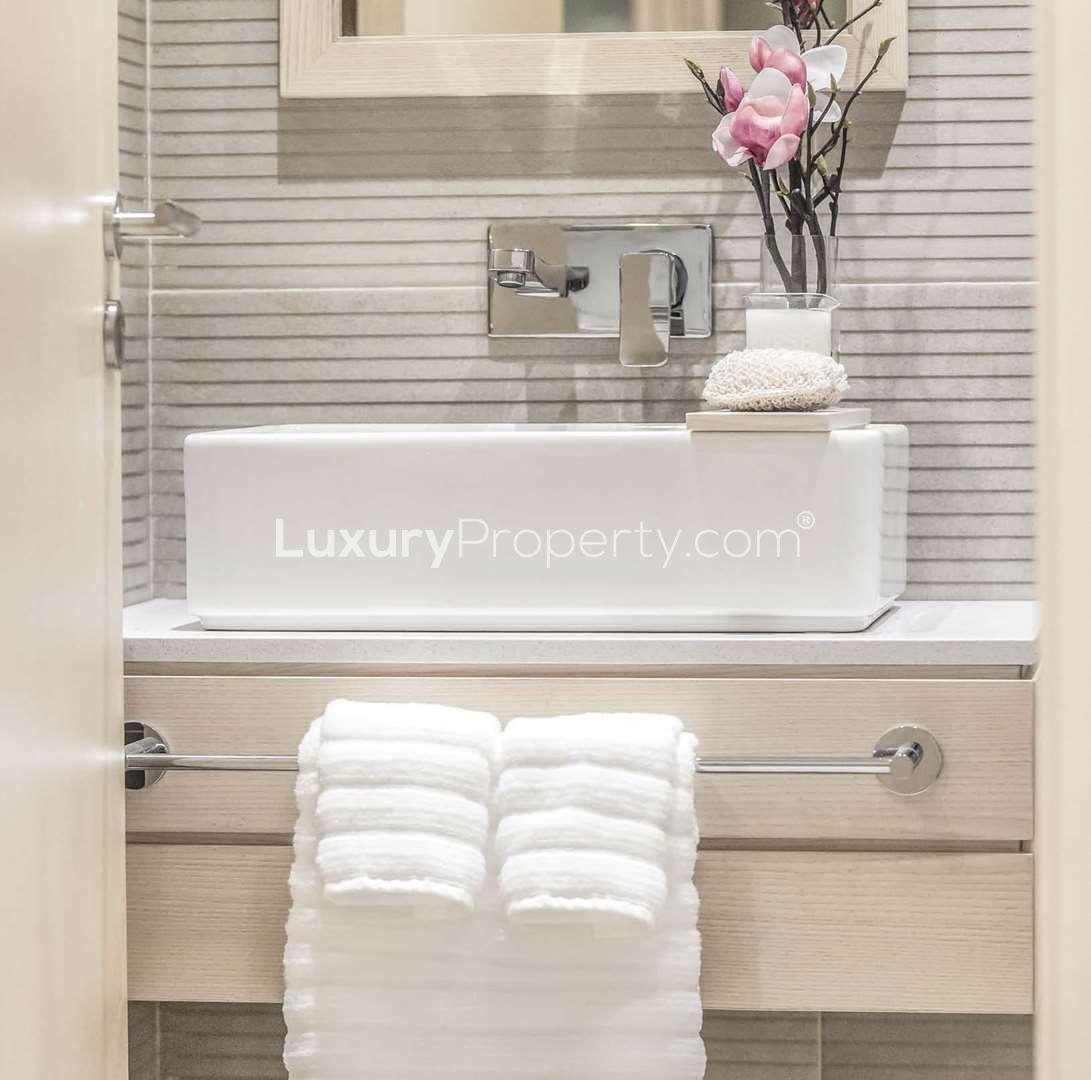 Elegant bedroom in luxury Belgravia apartment, Jumeirah Village Circle, with modern decor