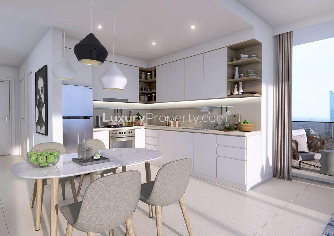 Modern kitchen in Downtown Views studio apartment, Downtown Dubai, featuring sleek design and dining area