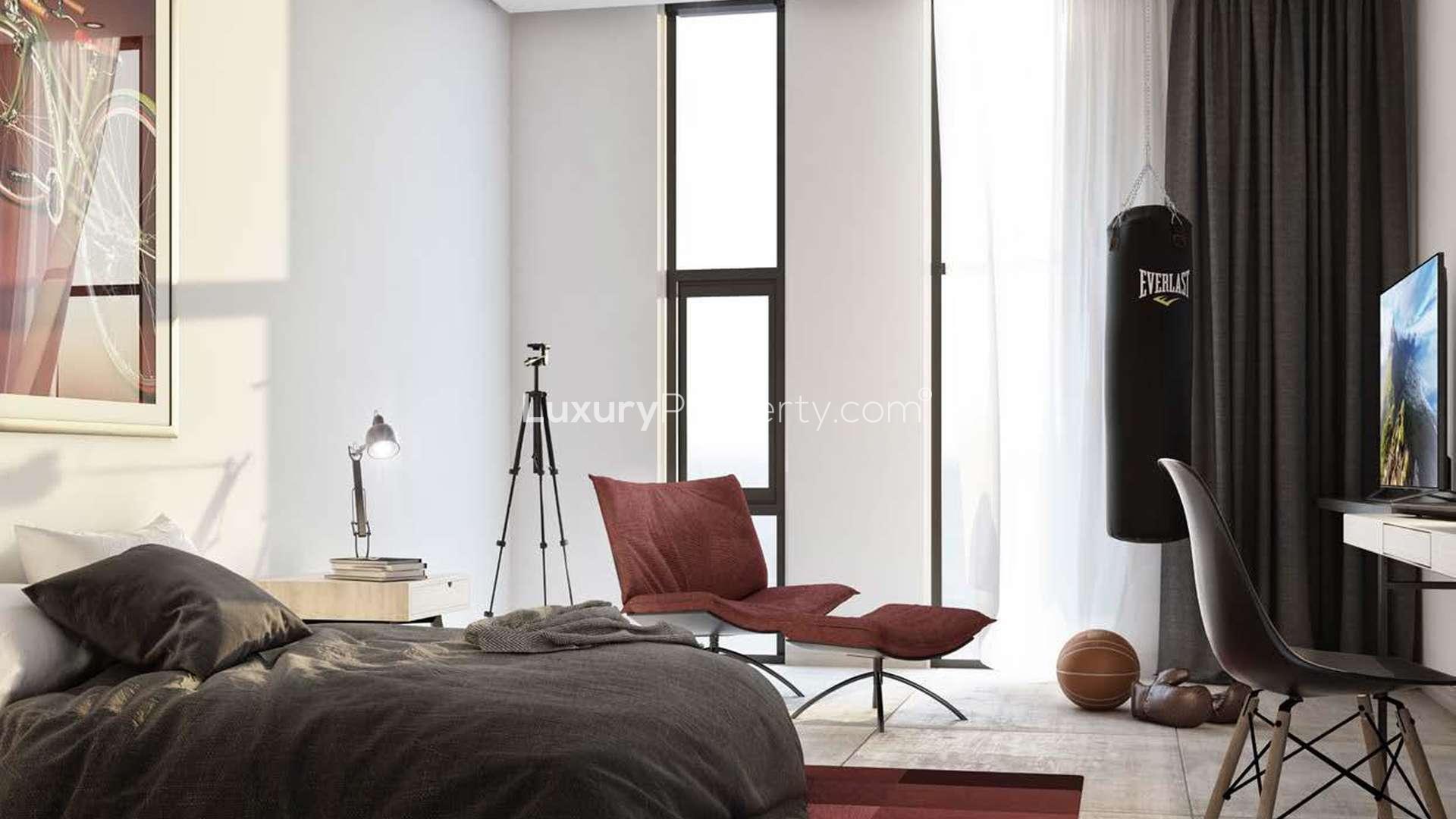 Modern bedroom in East Village apartment, Aljada, Sharjah, featuring stylish decor and natural light