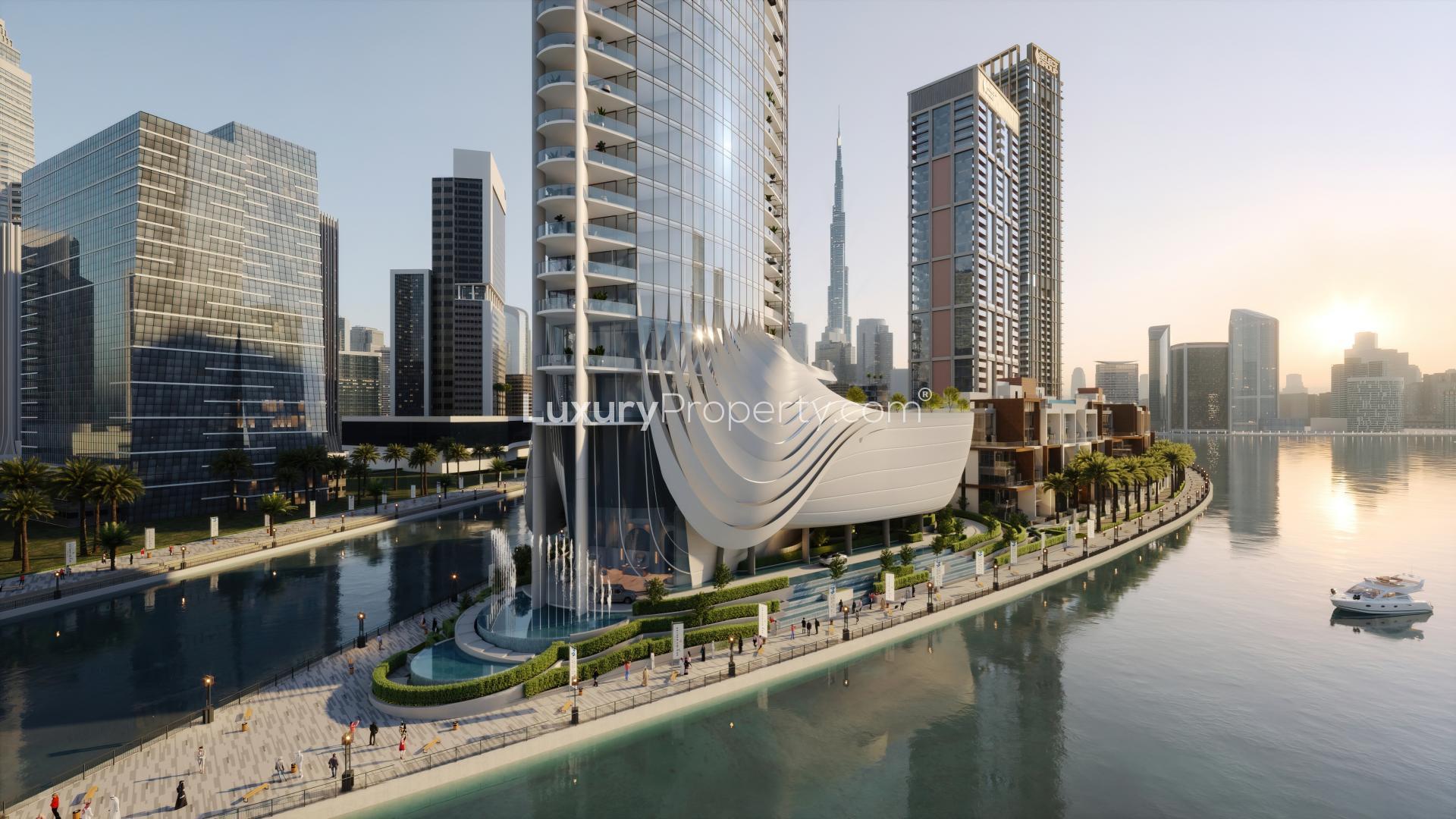 Jumeirah Living Business Bay apartment tower with stunning skyline and waterfront views at sunset