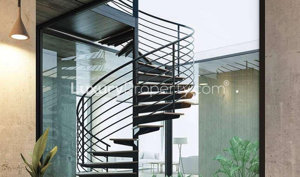 Luxury KOA Canvas apartment courtyard with modern staircase and water feature, Al Barari Dubai