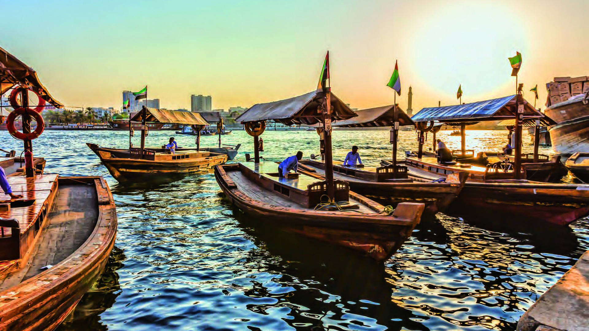 "Sunset view of traditional boats near Manazel Al Khor, Dubai Creek waterfront apartments.",Studio interior at Manazel Al Khor, Dubai Creek with luxury decor and waterfront view