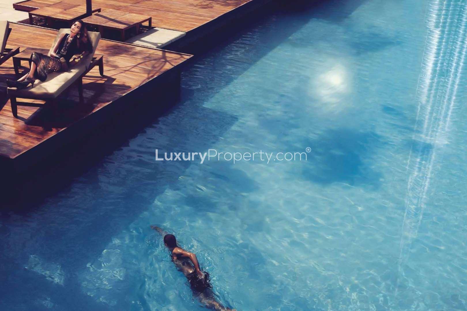 "Opera Grand Residence view of vibrant Dubai fountains, Downtown Burj Khalifa area at night.",Luxurious poolside area at Opera Grand Residence, Downtown Dubai, Burj Khalifa Area