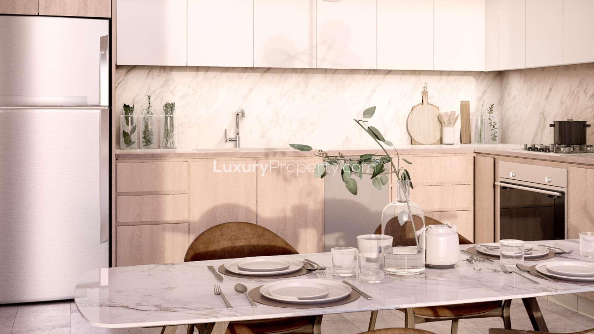 Modern kitchen in Park Field studio apartment, Dubai Hills Estate, with elegant dining setup